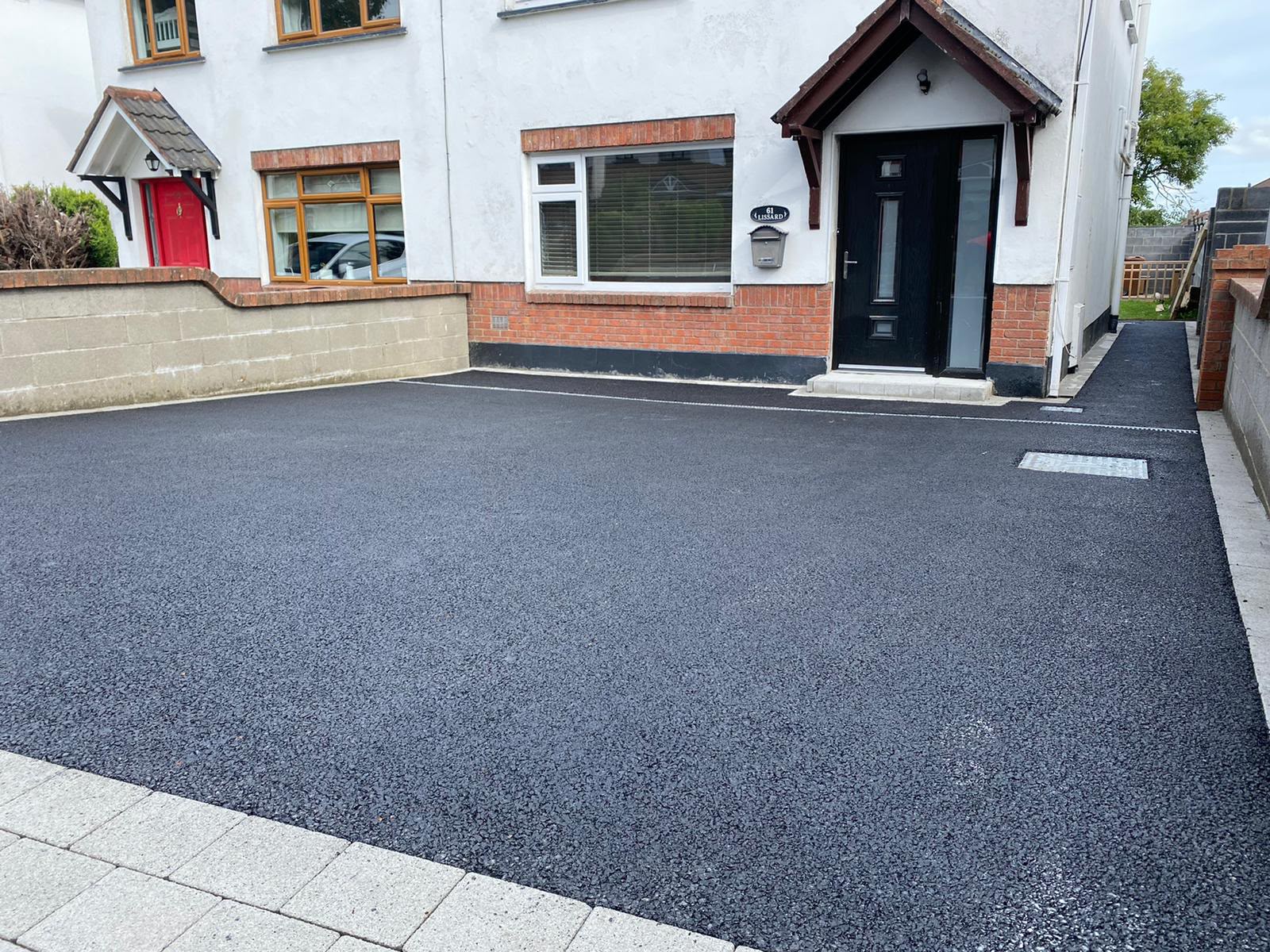 Completed tarmac driveway in front of a home