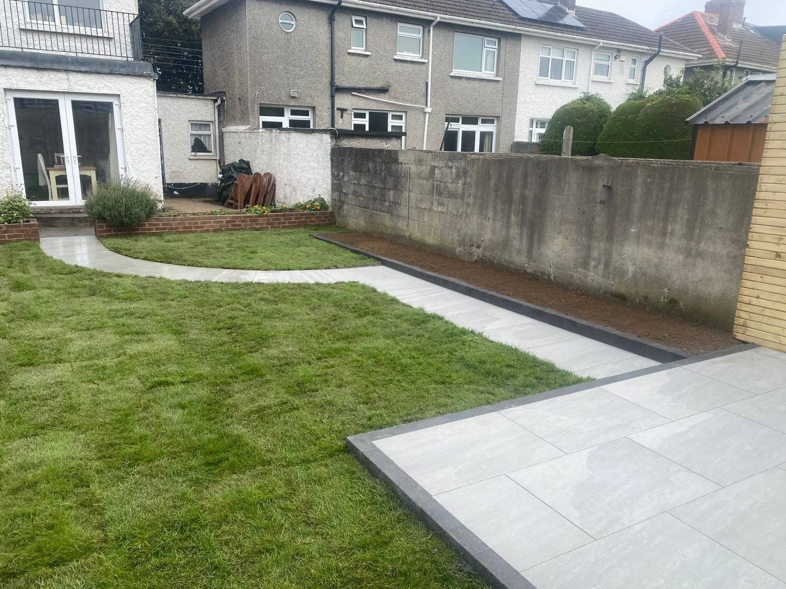 Porcelain paving beside lawn area