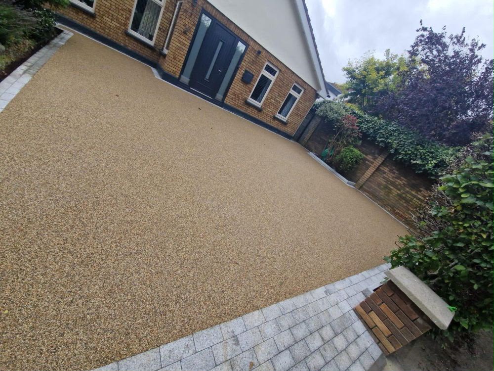 Tan resin driveway outside a brick home